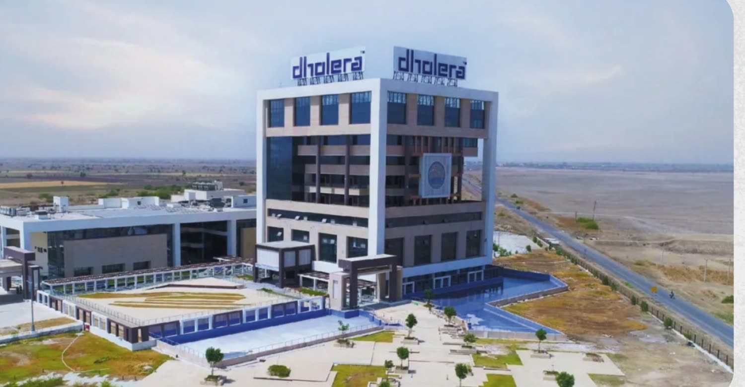 Aerial photograph of the ABCD command and control building in Dholera, with open land stretching away beside it